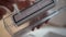 Close-up hands of unrecognizable man cleaning garbage can of robot vacuum cleaner. Close up side view of male doing