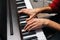 Close-up hands of unrecognizable musician man playing on digital electronic piano synthesize at home.