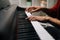 Close-up hands of unrecognizable musician man playing on synthesize at home studio.