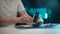 Close-up hands of unrecognizable repairman cleaning case of modern desktop video game card using wet wipes, during