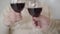 Close-up hands of unrecognizable senior man and woman clinking glasses with wine and kissing. Caucasian couple of