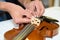 Close up hands and violin repair