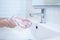 Close up of hands washing with soap in sink