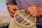 Close up hands weaving bamboo steamer in northeastern village of