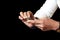 Close-up of hands woman creating clay buffalo isolated on black