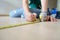 Close up hands woman engineer with yellow carpenters tape measuremeasure tape at construction site. background construction