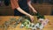 Close-up, hands of a woman florist at work. A woman seller, the owner of a flower shop, makes a beautiful floral bouquet