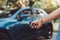 Close up hands woman pressing remote systems key near car