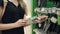 Close-up of hands of woman, rotating new metal shovel in store