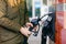 Close-up of hands of woman at self-service gas station, hold fuel nozzle and refuel the car with petrol, diesel, gas