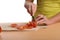 Close-up on hands of woman slicing tomatos