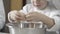 close-up of hands of a young chef learning to break eggs. ingredients to prepare cake. son with white chef uniform