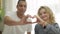 Close-up hands of young interracial loving happy couple making heart shape with blurred smiling African American man and