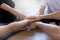 Close up hands of young people girls and guys hold stack hands together, gesture symbol of support