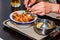 Close up hands of young woman eating shrimps in restaurant