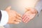 Close up handshake of business people in meeting attendance.