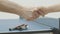 Close-up handshake of Caucasian man and woman in gym. Unrecognizable young sportsman and sportswoman shaking hands at