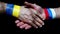 close-up of the handshake. male hands with ribbons on the wrists of the colors of the Russian and Ukrainian flags are