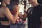 Close up handshake of sporty young asian woman with man greeting partner exercise workout at fitness gym