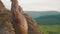 Close-up of handsome african american bodybuilder stretching outdoor. Mountain landscape background