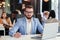 Close up handsome confident bearded office manager in business suit works with laptop at the office room.