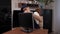 Close-up of a handyman in overalls repairs a computer monitor at a client\'s home