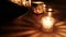 Close-up on hang drum lying in dark next to some bright candles