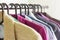 Close - up hangers with different clothes.Shirts and jackets of different colors hanging on a hanger