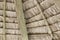 Close-up of hanging edge of thatched umbrellas on beach