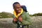 Close up happy african american man hiking with backpack in nature