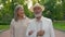 Close up happy aged family elegant couple Caucasian retired senior man walking holding hand elderly smiling woman lovers