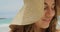 Close-up of Happy Caucasian woman in hat standing on the beach 4k