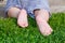 Close up. Happy Child Feet Barefoot on Green Grass. Healthy Lifestyle. Spring Time. Rear view. the concept of flatfoot, the child