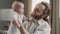 Close-up happy father loving caring middle-aged dad bearded man holding little daughter son child jumping laughing male