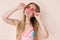 Close Up Of Happy Girl in pink sunglasses isolated. Summer holidays and fun time weekend. Summertime concept. Smiling young woman