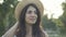 Close-up of happy gorgeous Middle Eastern woman standing in sunrays outdoors and smiling. Beautiful charming lady