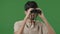 Close up happy hispanic guy using binoculars indian cheerful tourist looking adventure studio green background portrait