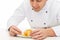 Close up of happy male chef cook decorating dessert