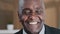 Close up happy male face 60s businessman elderly African American man grandpa satisfied client dentistry service