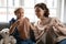 Close up happy mature grandmother and little granddaughter knitting together