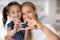 Close up of happy mom and daughter make heart gesture