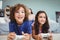 Close-up of happy siblings with controllers playing video game