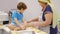 Close up of the happy smiled grandmother and grandson kneading a daugh together. slow motion of an elderly woman and