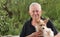 Close-up of a happy, smiling senior man holding his cute little dog