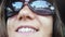 Close up of happy young smiles woman wears sunglasses sitting in car passenger looking out window on sunny day enjoying