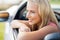 Close up of happy young woman in convertible car