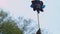 Close up of a happy young woman holding pinwheel in sunny park.