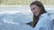 Close-up of a happy young woman by the mountain river