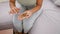 Close-up of a hardworking woman\\\'s hands carefully counting coins on a comfy sofa at home, maintaining her financial independence