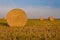 Close-up of a hay cylindrical bale in a farmland